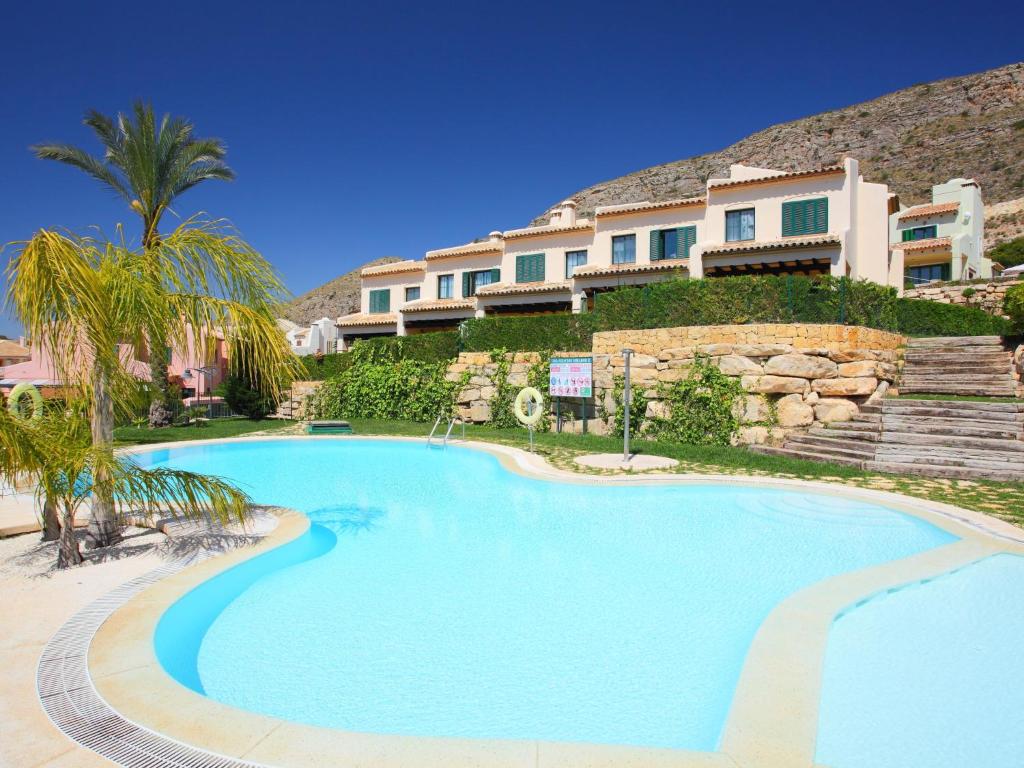 a swimming pool in front of a resort at Holiday Home Mirador II by Interhome in Cala de Finestrat