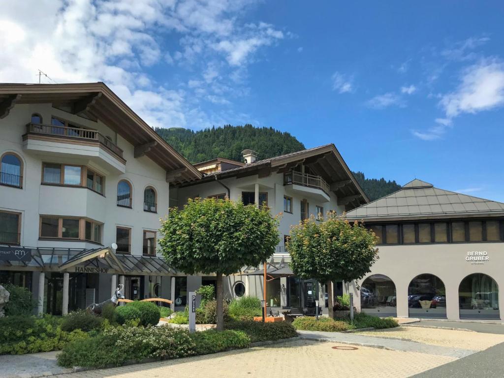 a large building with trees in front of it at Apartment Hanneshof-2 in Aurach bei Kitzbuhel