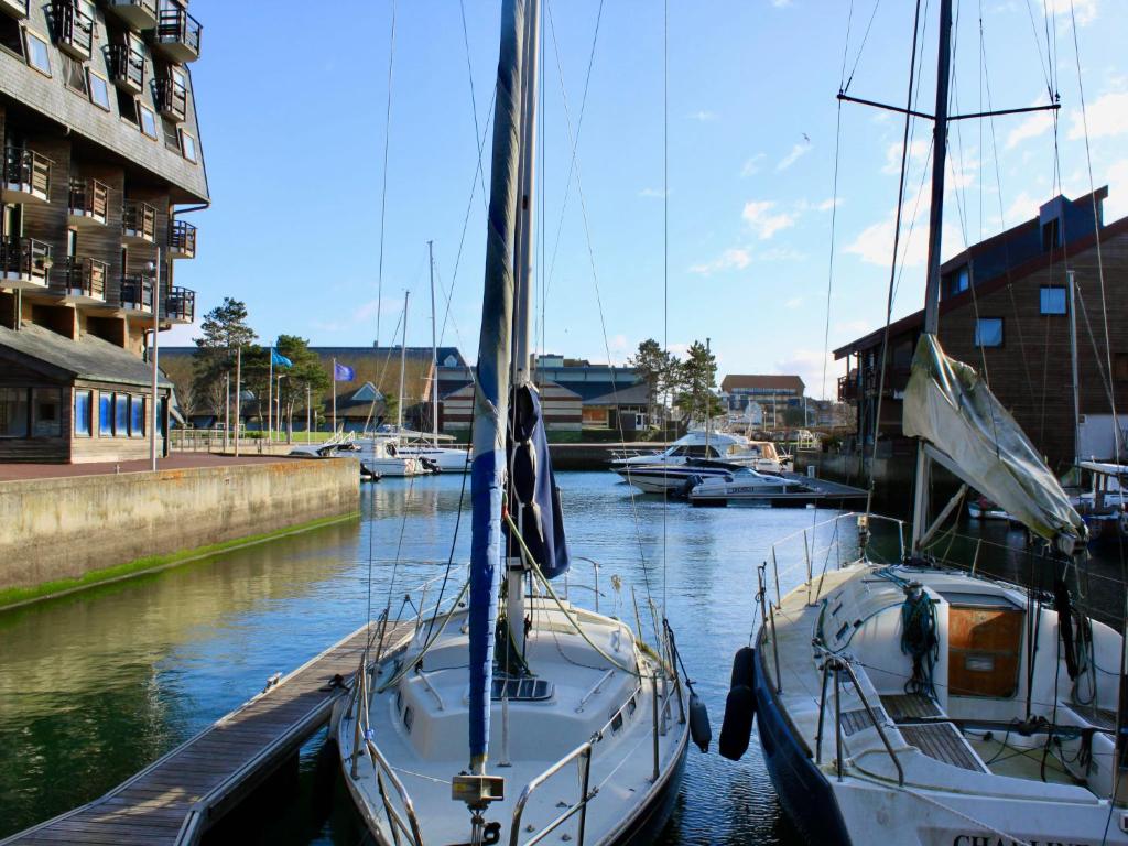 two boats docked at a dock in the water at Studio Les Marinas-4 by Interhome in Deauville