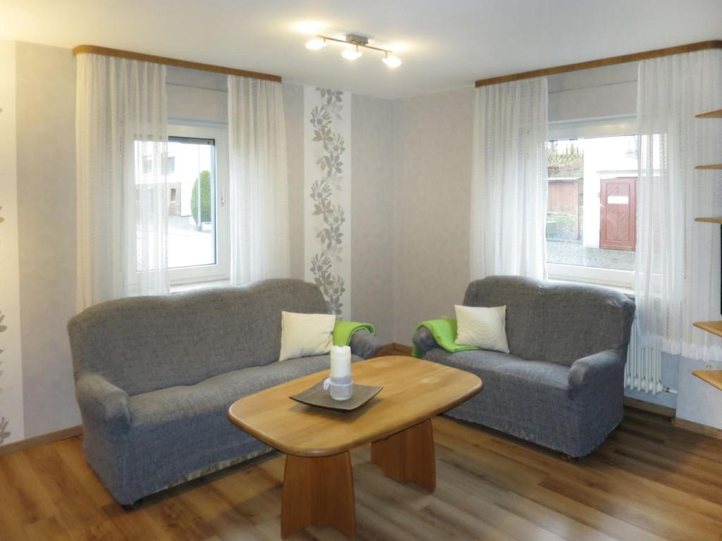 a living room with two couches and a coffee table at Holiday Home Haus Irmgard by Interhome in Haserich