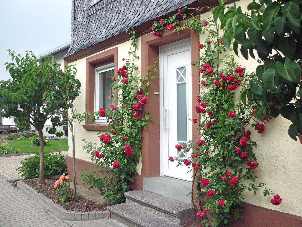 a house with roses on the side of it at Holiday Home Haus Irmgard by Interhome in Haserich