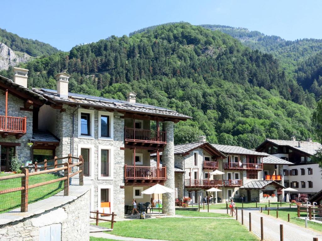 a group of buildings in a village with a mountain at Apartment La Borgata - SMY726 by Interhome in Sampeyre