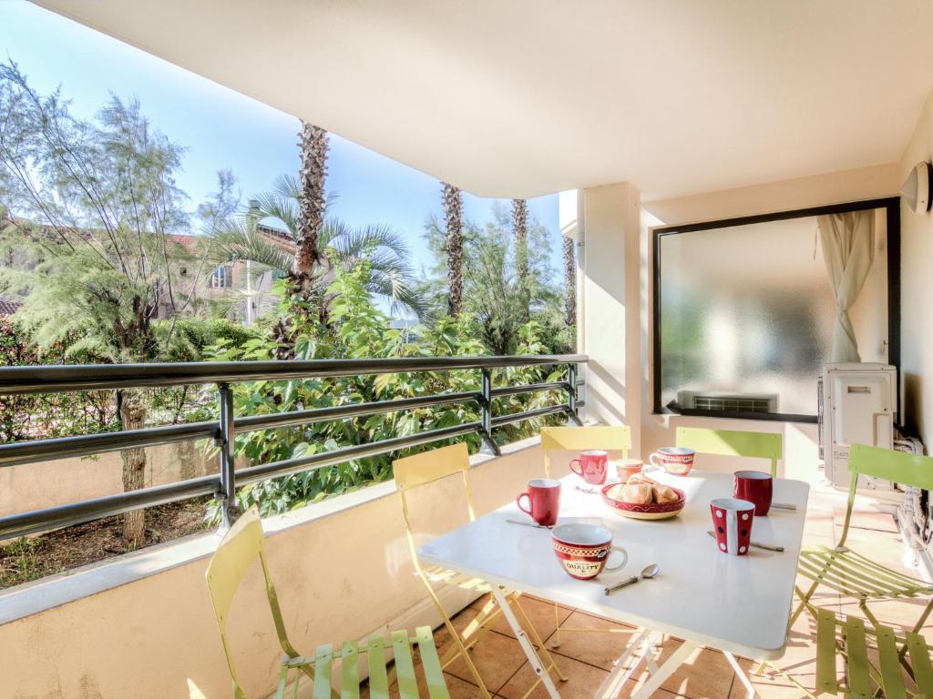a table and chairs on a balcony with a view at Apartment Le Magellan-1 by Interhome in Saint-Raphaël