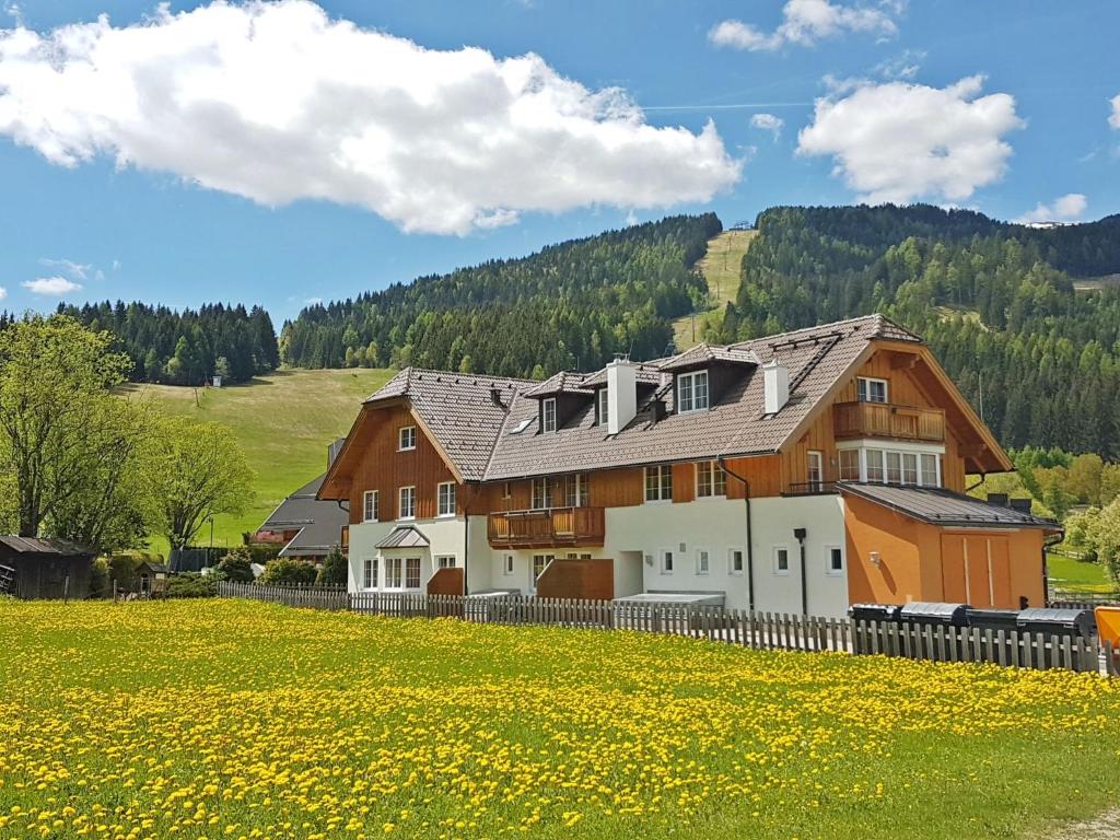 a house in the middle of a field of flowers at Apartment Top 7 by Interhome in Sankt Margarethen im Lungau