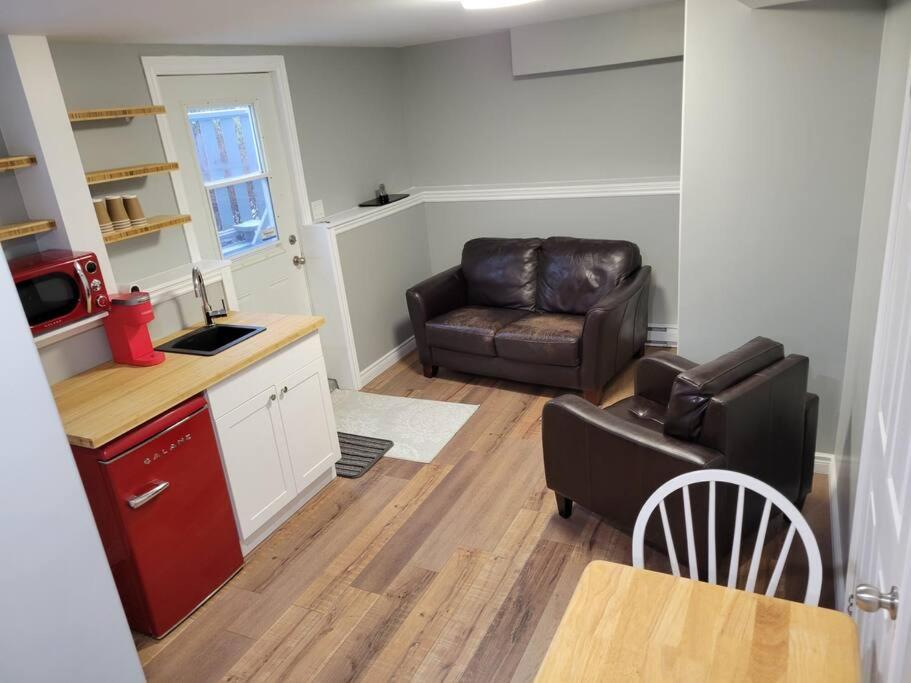 a living room with a couch and a chair at Stylish one bedroom Apartment. 