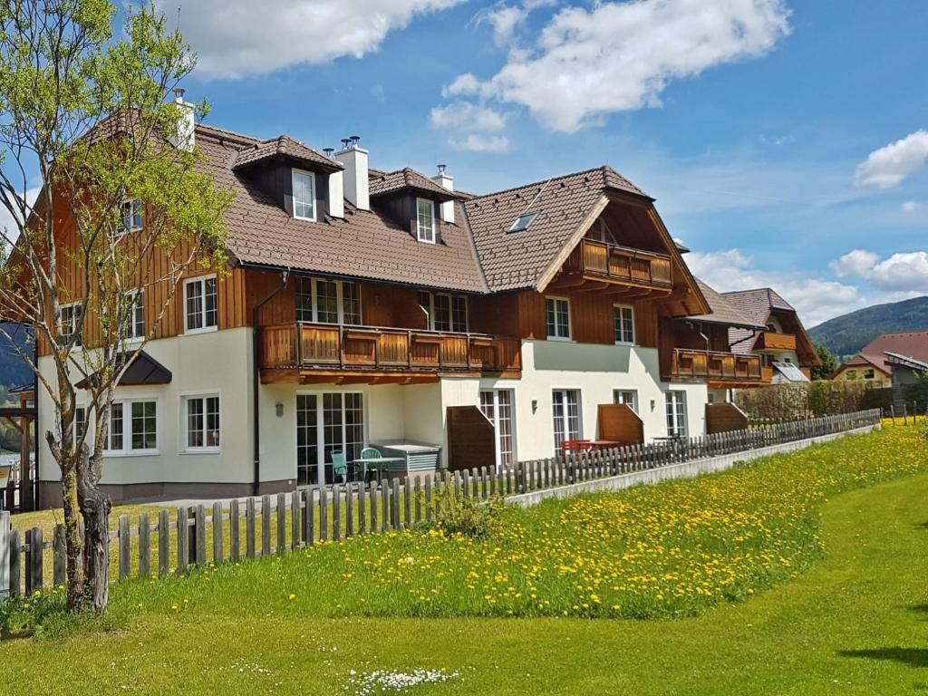 a large house with a fence in front of it at Apartment Aineckblick-7 by Interhome in Sankt Margarethen im Lungau