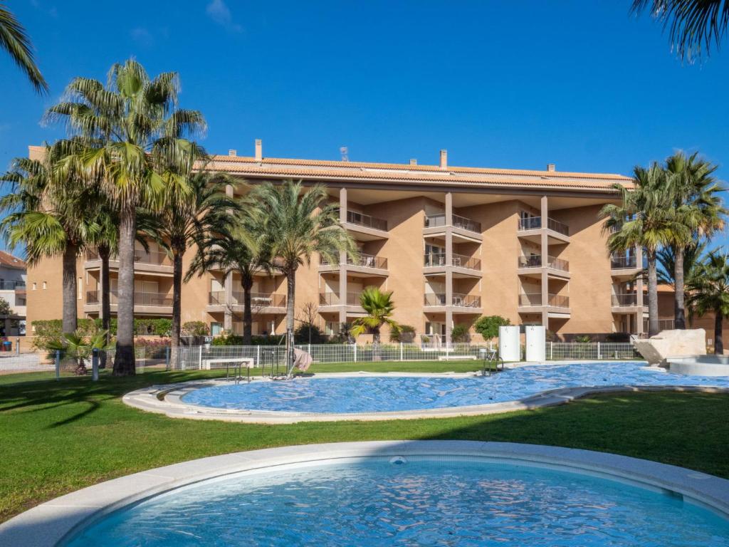 a large building with palm trees and a swimming pool at Apartment Marmara-4 by Interhome in Jávea