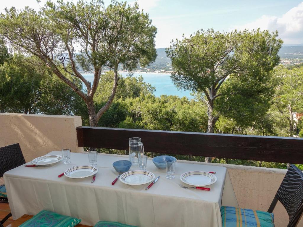 a table with a white table cloth and a view of the ocean at Apartment Mas de la Madrague-8 by Interhome in La Madrague