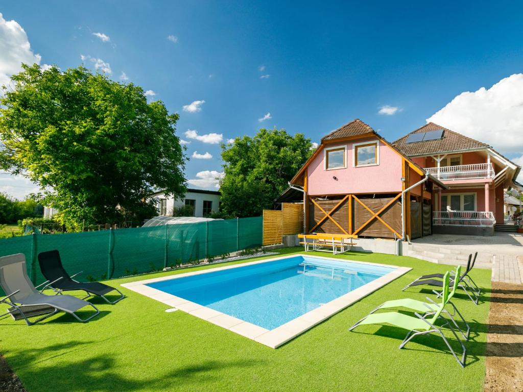 a backyard with a swimming pool and a house at Holiday Home Zsuzsi by Interhome in Balatonszemes