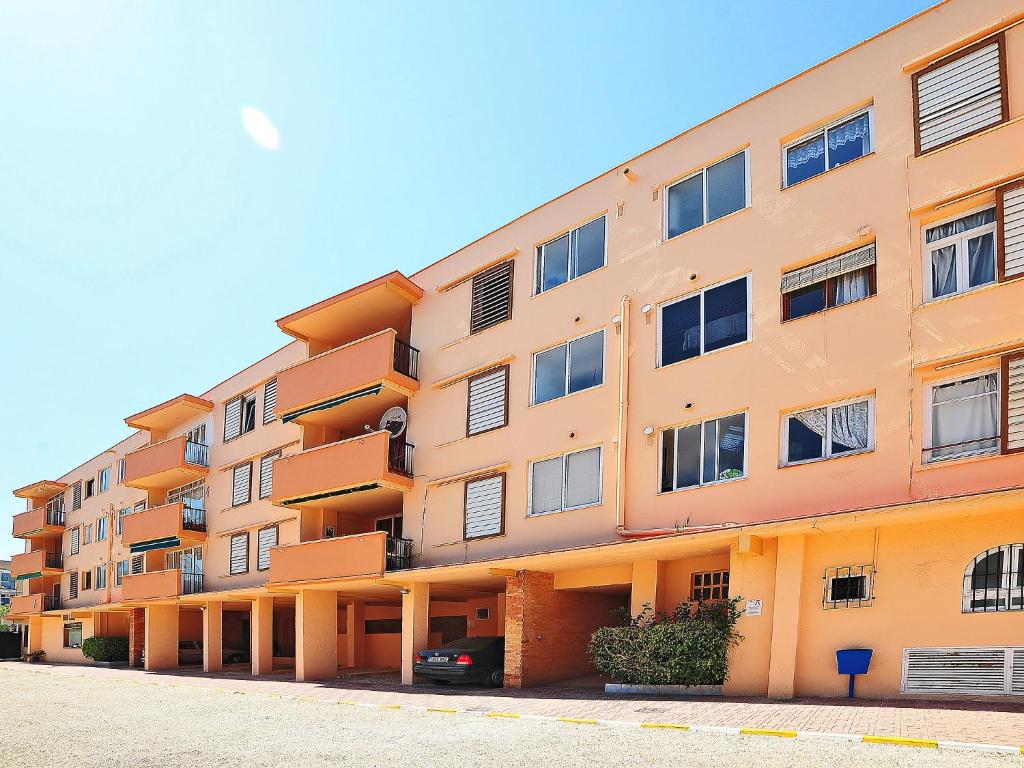 an orange apartment building with a car parked in front at Apartment L'Ancora by Interhome in Jávea