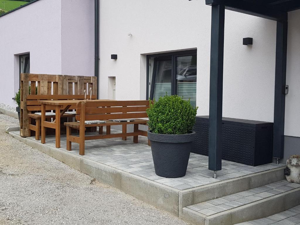 two wooden benches sitting outside of a building at Apartment Stefanie by Interhome in Taxenbach