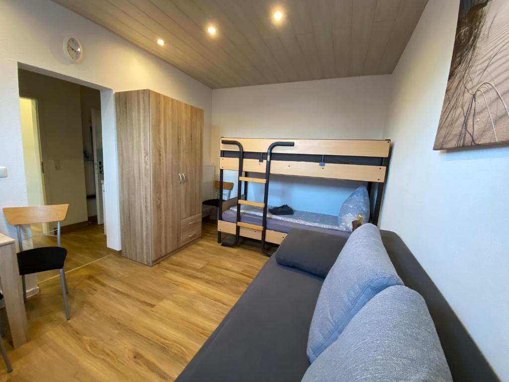 a living room with a couch and a bunk bed at Pensionszimmer Hannes in Lübeck