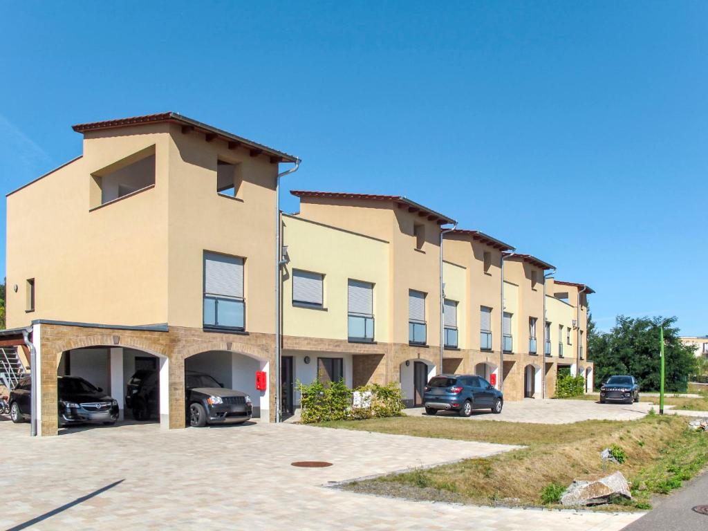 a large building with cars parked in a parking lot at Apartment Piratennest by Interhome in Großpösna