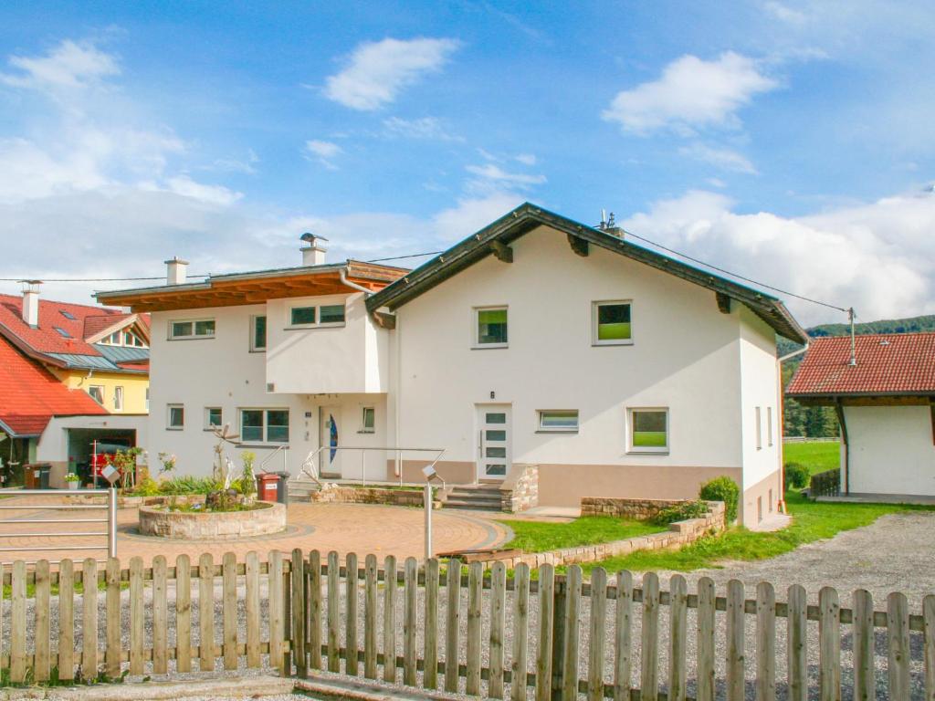 a white house with a fence in front of it at Holiday Home Mitzi by Interhome in Wildermieming