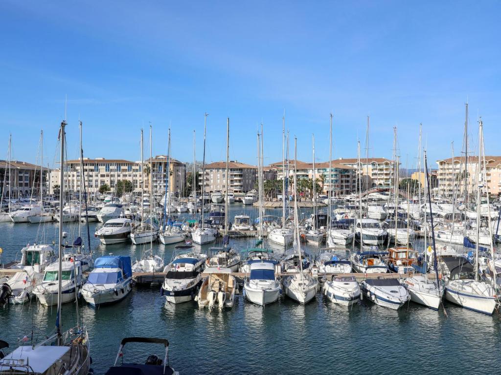 a bunch of boats docked in a harbor at Apartment Résidence Les Cariatides by Interhome in Fréjus
