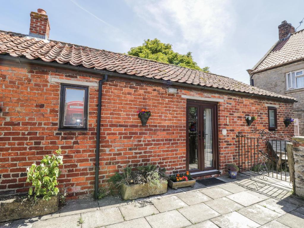 a red brick house with a front door at Chestnut Cottage in Great Edston