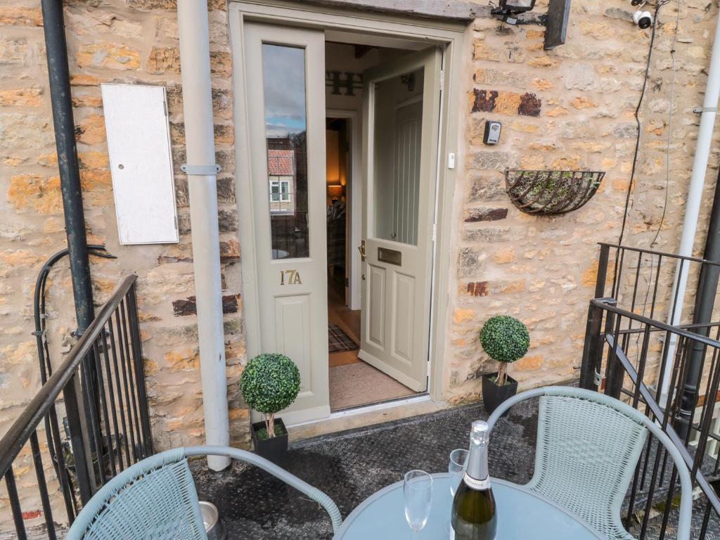 a patio with a table and chairs in front of a building at The Smithy in York