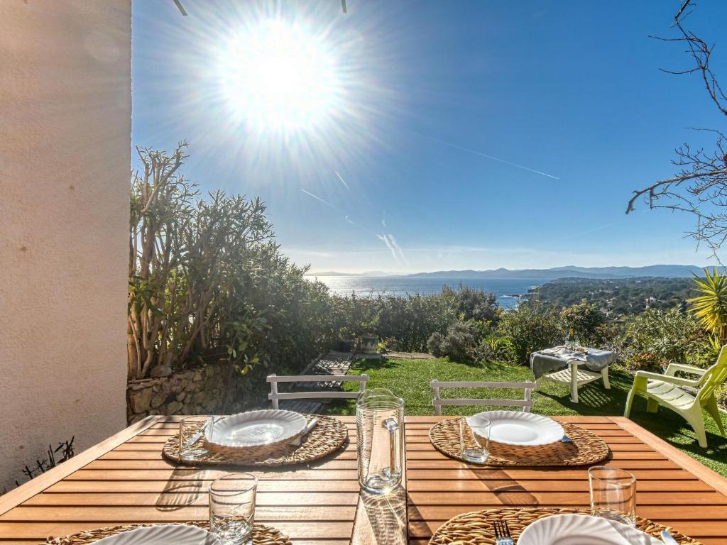 a table with plates and glasses on top of a deck at Holiday Home Panorama by Interhome in Drammont