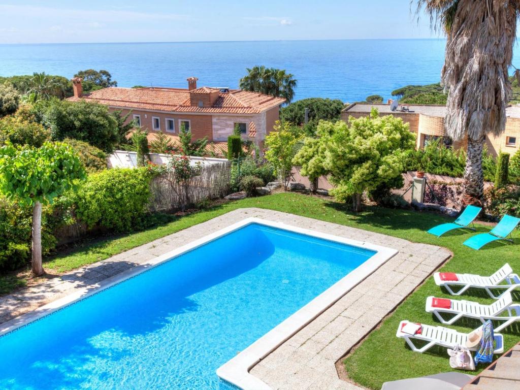 a villa with a swimming pool and the ocean at Villa Macedonia by Interhome in Lloret de Mar