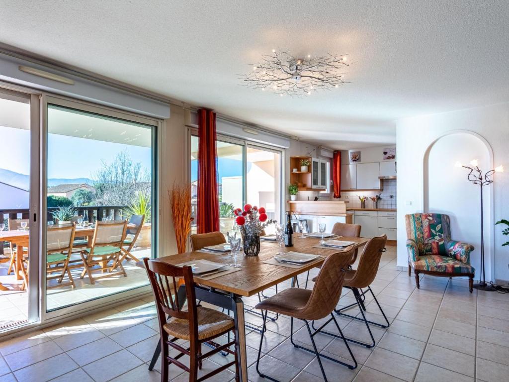 a kitchen and dining room with a table and chairs at Apartment Les Reflets by Interhome in Saint-Cyprien-Plage