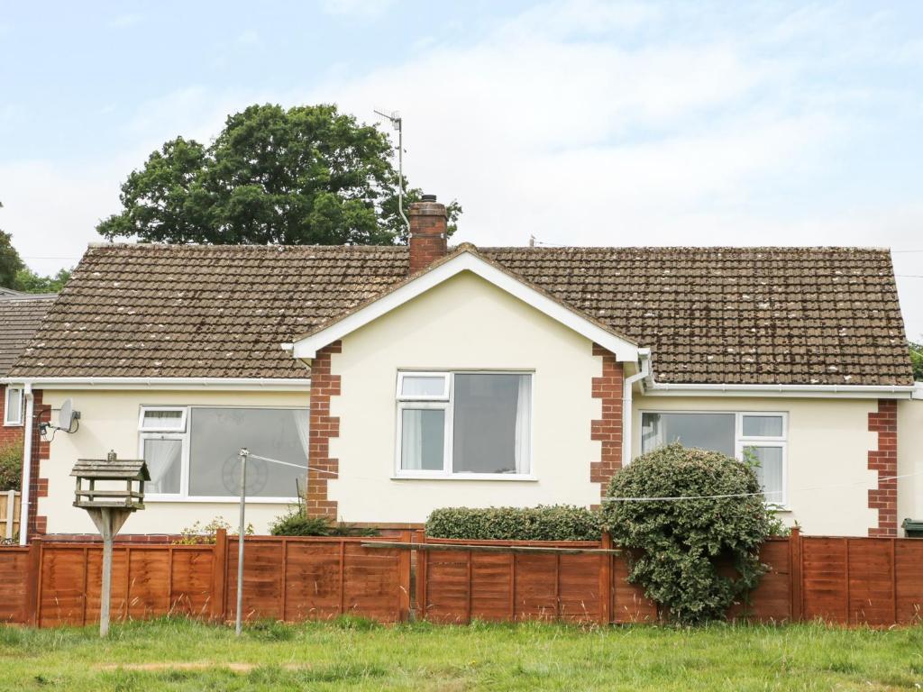 a house with a wooden fence in front of it at Glebeland in Bishops Castle