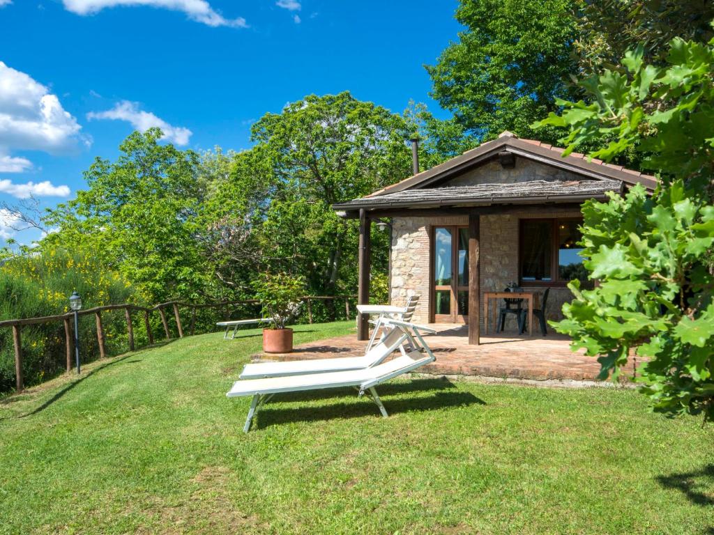 a bench in a yard with a gazebo at Holiday Home Casale Belvedere by Interhome in Roccastrada