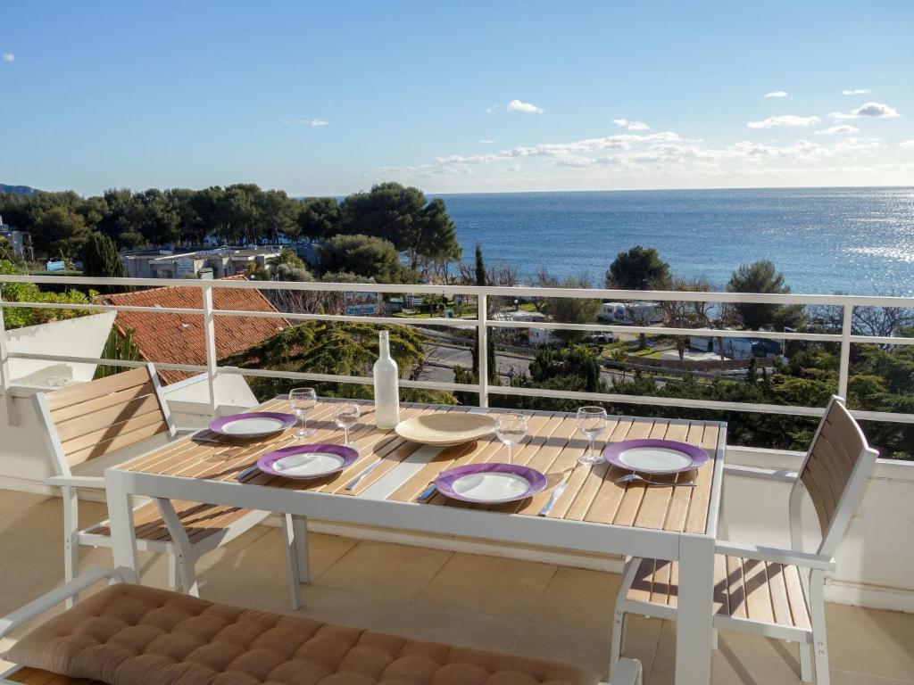 een witte tafel en stoelen op een balkon met uitzicht op de oceaan bij Apartment Les Hauts de Fonsainte by Interhome in La Ciotat