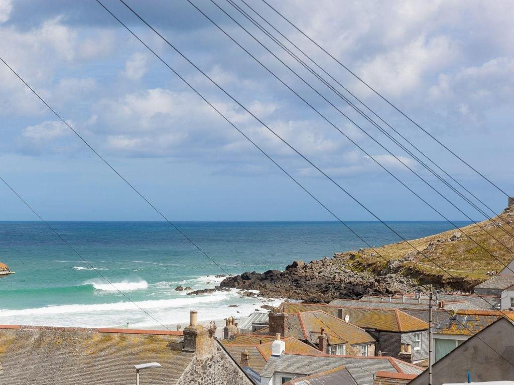 a view of the ocean from a town at Hepworth Apartment in St Ives