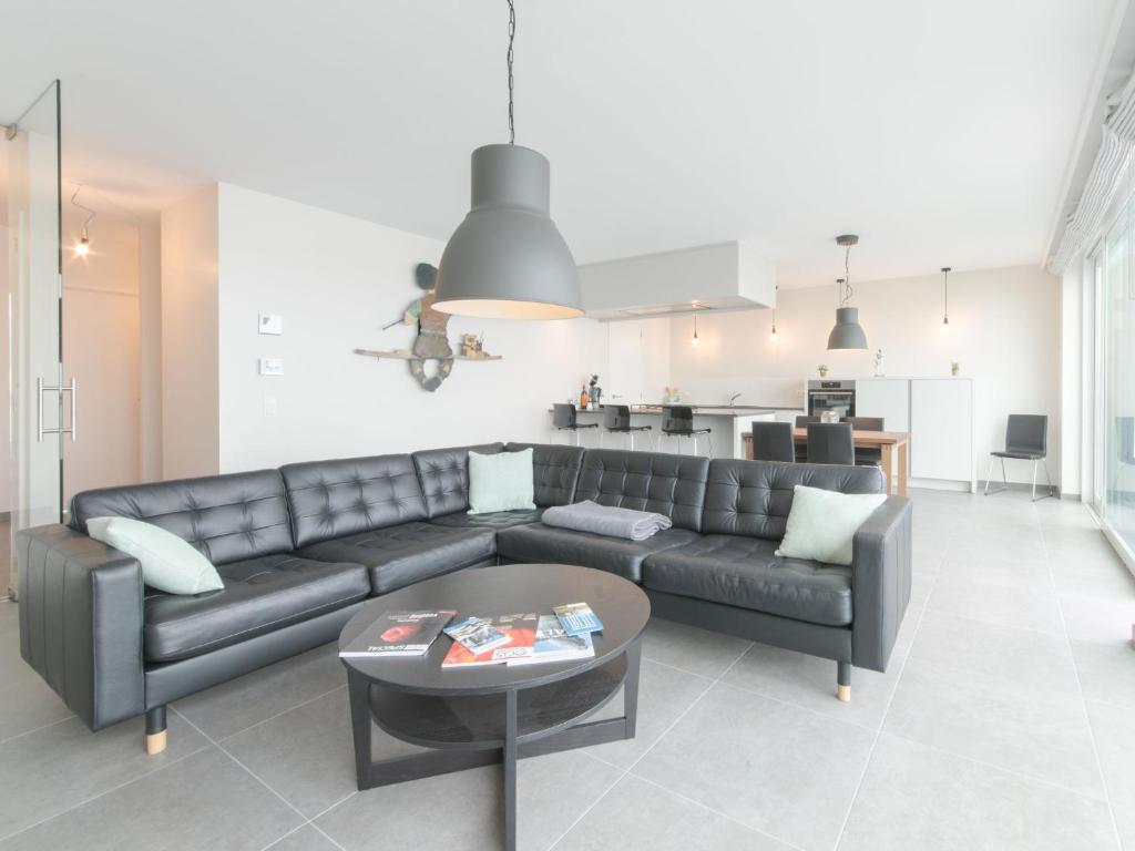 a living room with a couch and a table at Apartment Lakeside by Interhome in Bredene