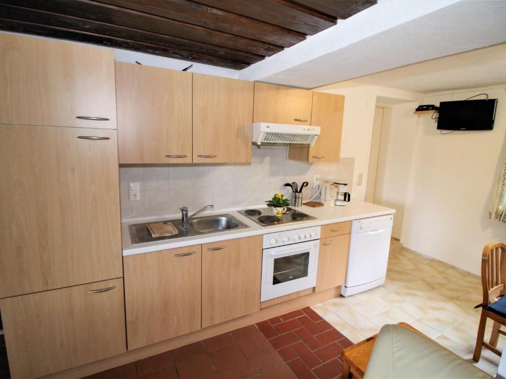 kuchnia z drewnianymi szafkami i zlewem w obiekcie Apartment Fuchsbau-Top 2 by Interhome w mieście Grünau im Almtal