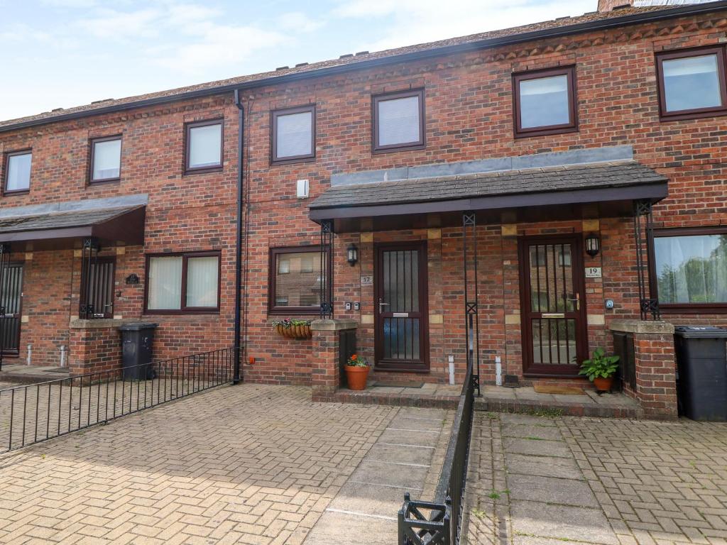 an old brick building with a courtyard in front of it at 17 Fewster Way in York