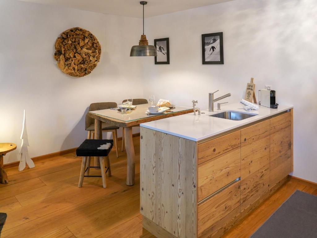 a kitchen with a sink and a wooden counter top at Apartment Chesa Palüdin 5 - Celerina by Interhome in Celerina