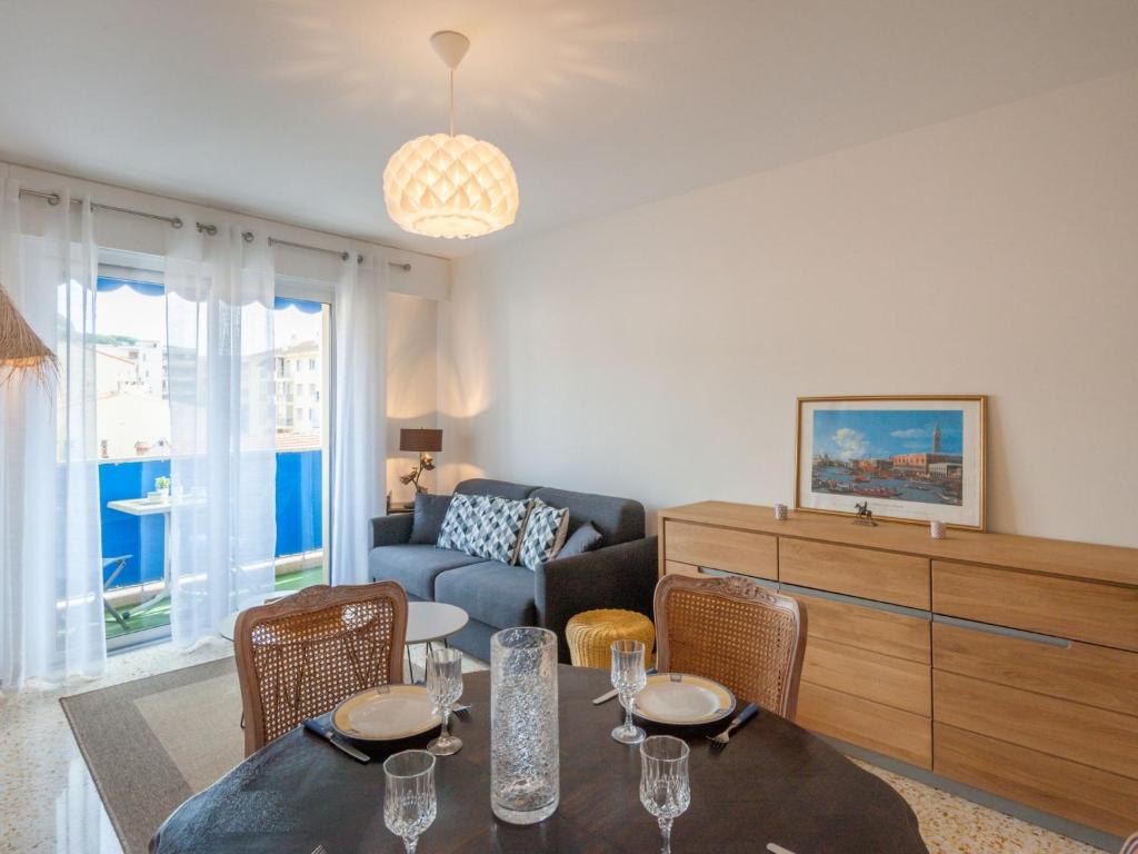 a living room with a table and chairs and a couch at Apartment L'Amiral-1 by Interhome in Cagnes-sur-Mer