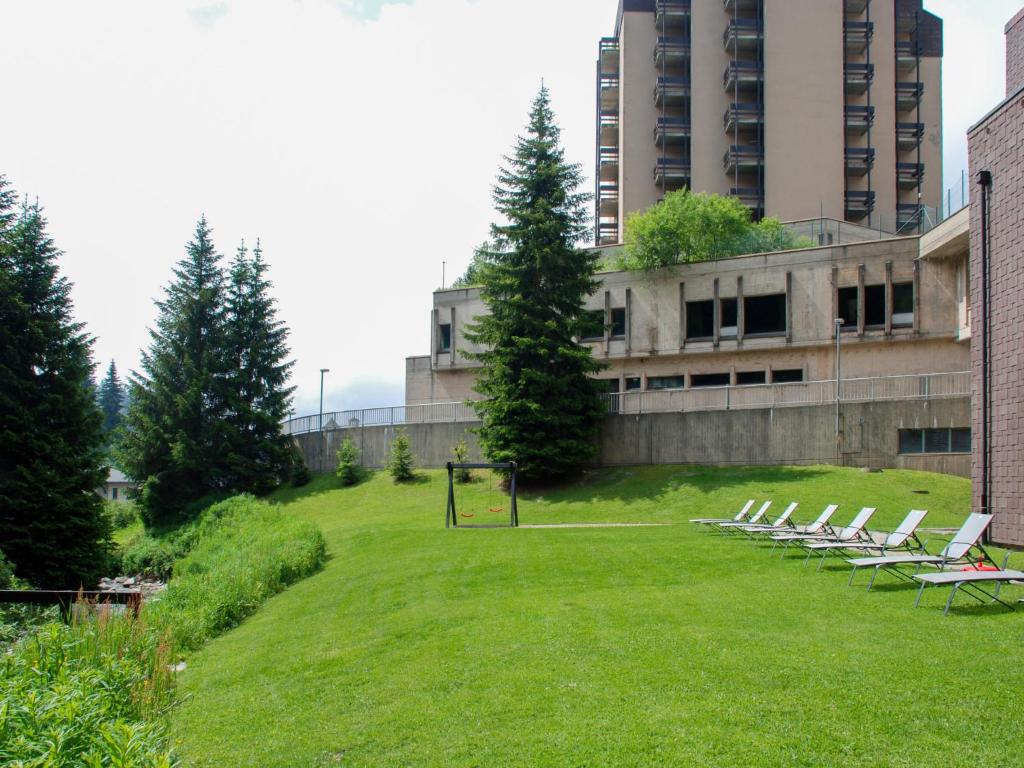 a group of lounge chairs sitting on a lawn in front of a building at Apartment Albarella Panorama by Interhome in San Bernardino