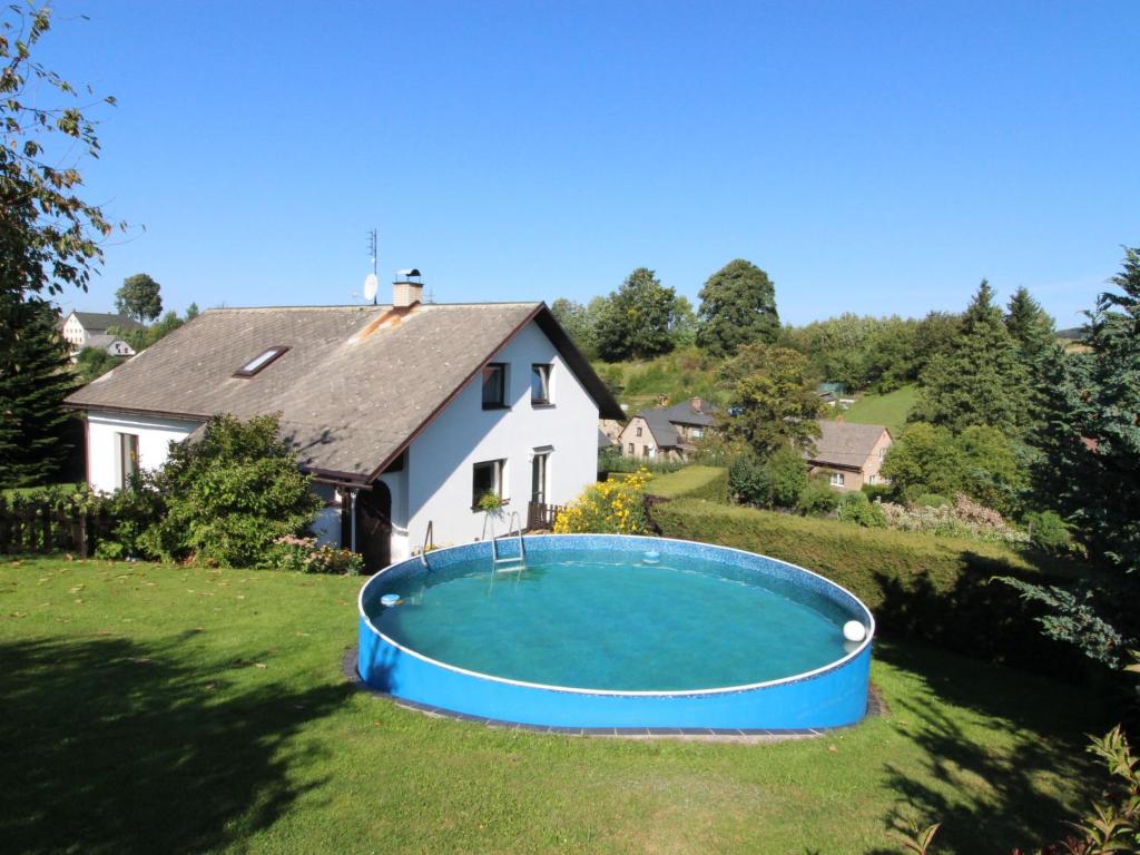 a large swimming pool in the yard of a house at Holiday Home Červený Kostelec by Interhome in Červený Kostelec