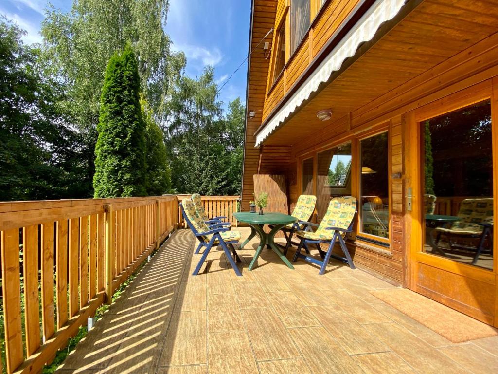 a deck with a table and chairs on a house at Holiday Home Gräfenroda by Interhome in Dörrberg