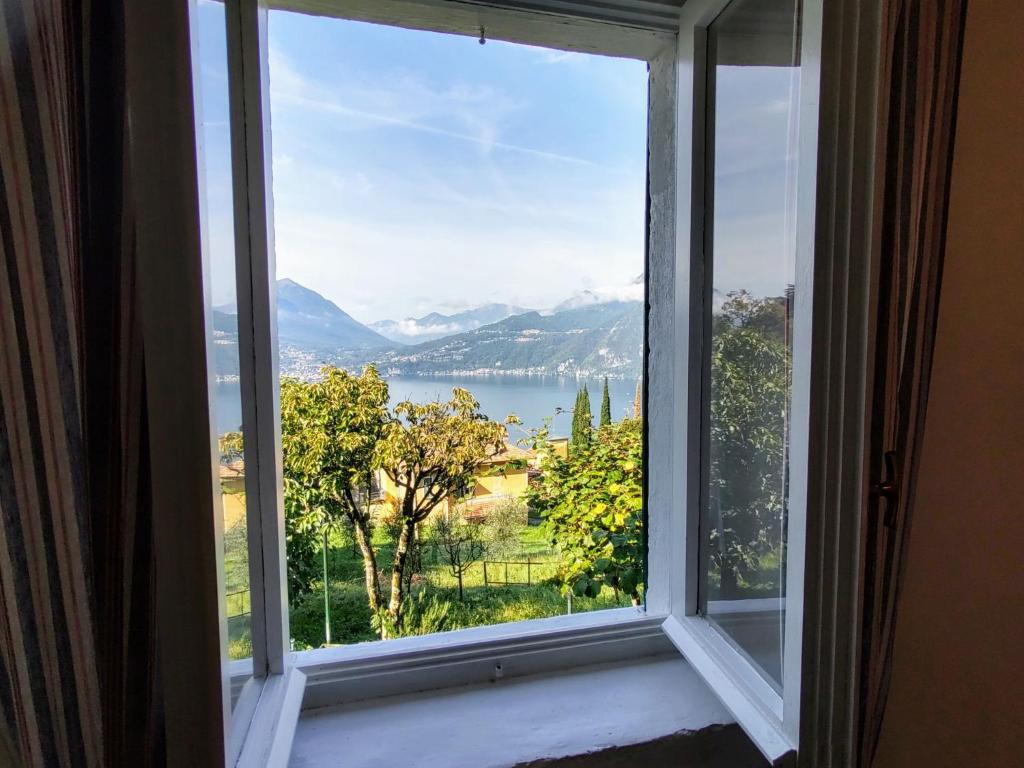 a window with a view of a lake and mountains at Holiday Home Giò by Interhome in Perledo
