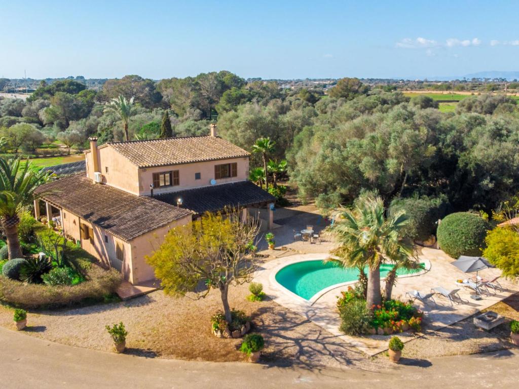 an aerial view of a house with a pool and trees at Holiday Home Es Rafalet by Interhome in Llucmajor