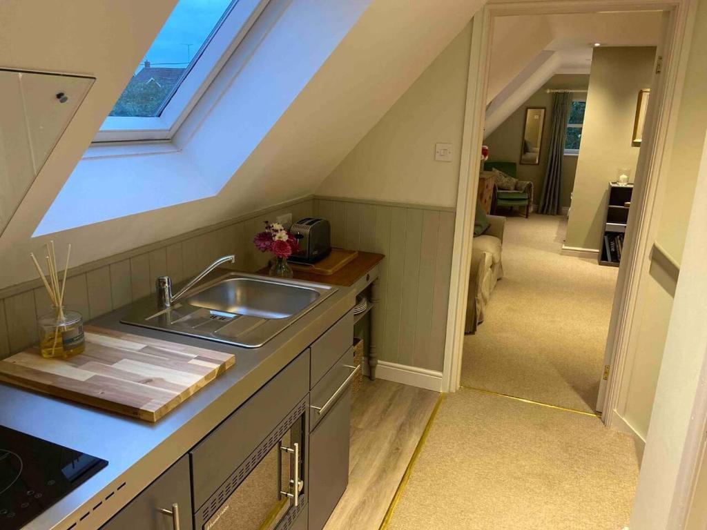 a kitchen with a sink and a attic at Stylish getaway in the heart of the Pewsey Vale in Pewsey