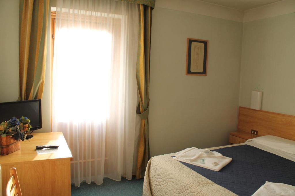 Postel nebo postele na pokoji v ubytování Hotel Villanova