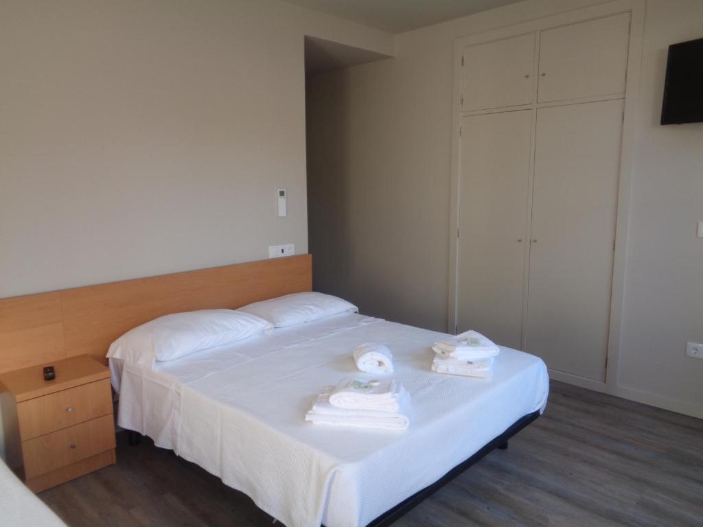 Postel nebo postele na pokoji v ubytování Rua Grande Hotel