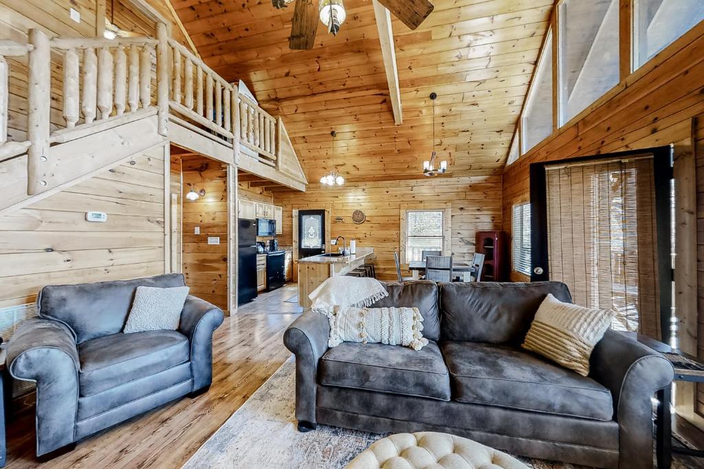 a living room with a couch and two chairs at Parton Ways in Pigeon Forge