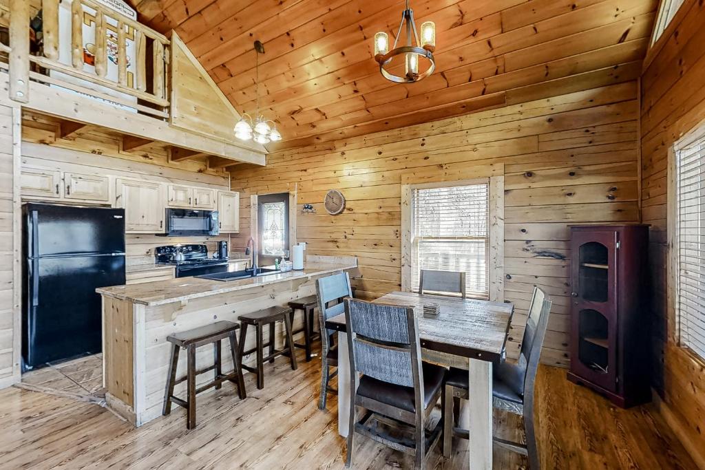 a kitchen with a table and chairs in a cabin at Parton Ways in Pigeon Forge