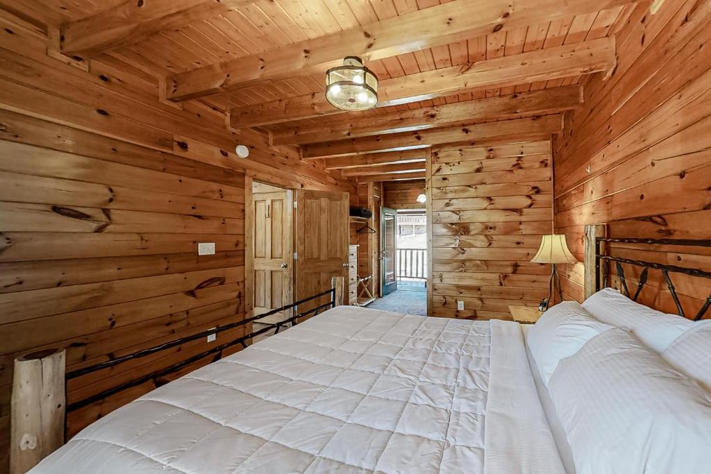 a bedroom with a large bed in a log cabin at Parton Ways in Pigeon Forge