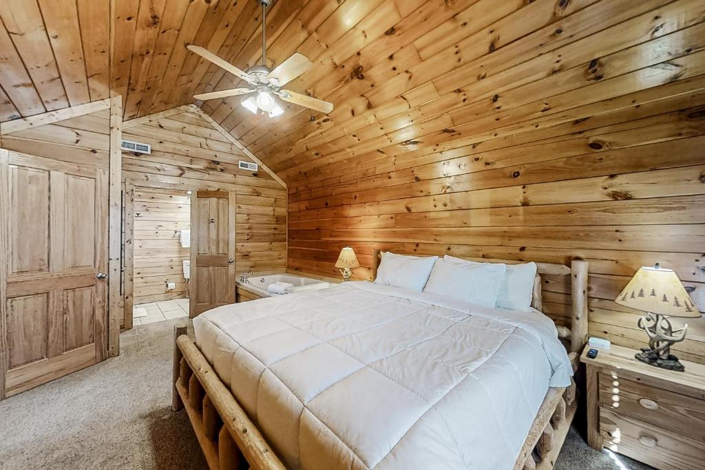 a bedroom with a bed and a wooden ceiling at Parton Ways in Pigeon Forge