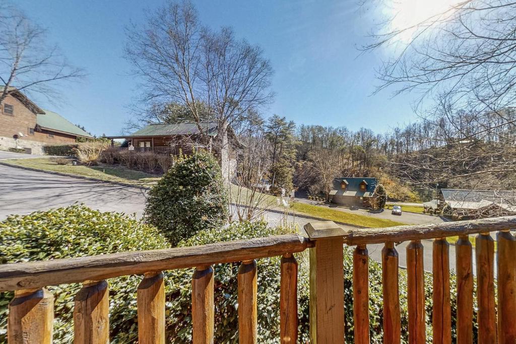a home with a wooden fence and a yard at Parton Ways in Pigeon Forge