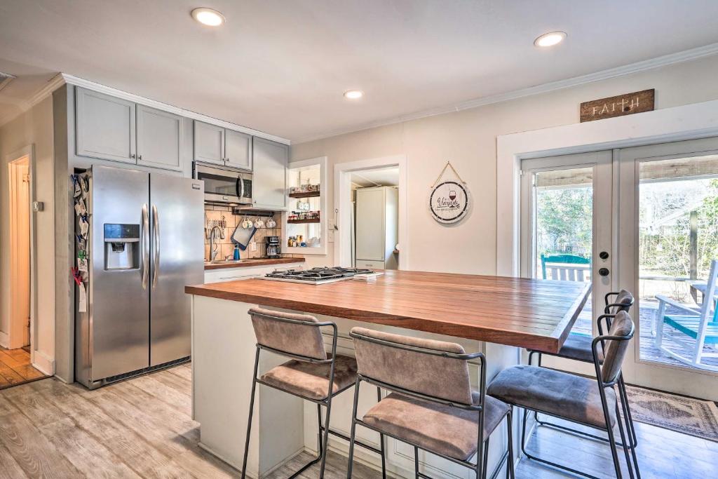 a kitchen with a wooden counter and a refrigerator at Cozy North Charleston Getaway with Fire Pit! in Charleston