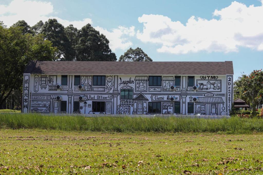 a building covered in graffiti on the side of a field at 2D Fantastic Villa Lot 1857 in Kampong Alor Gajah