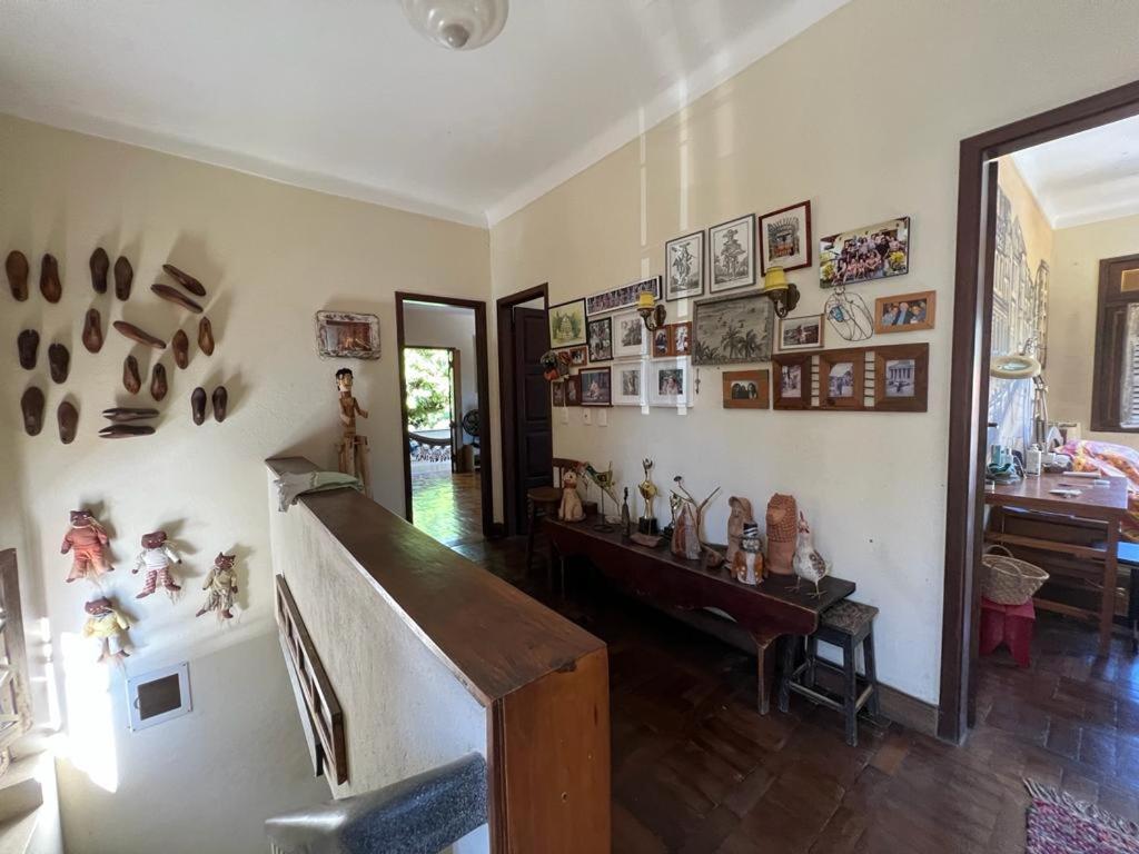 a living room filled with lots of items on the wall at Charme do Poço in Recife