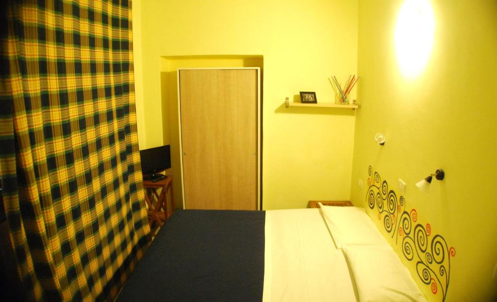 Postel nebo postele na pokoji v ubytování AlbergoTeatro